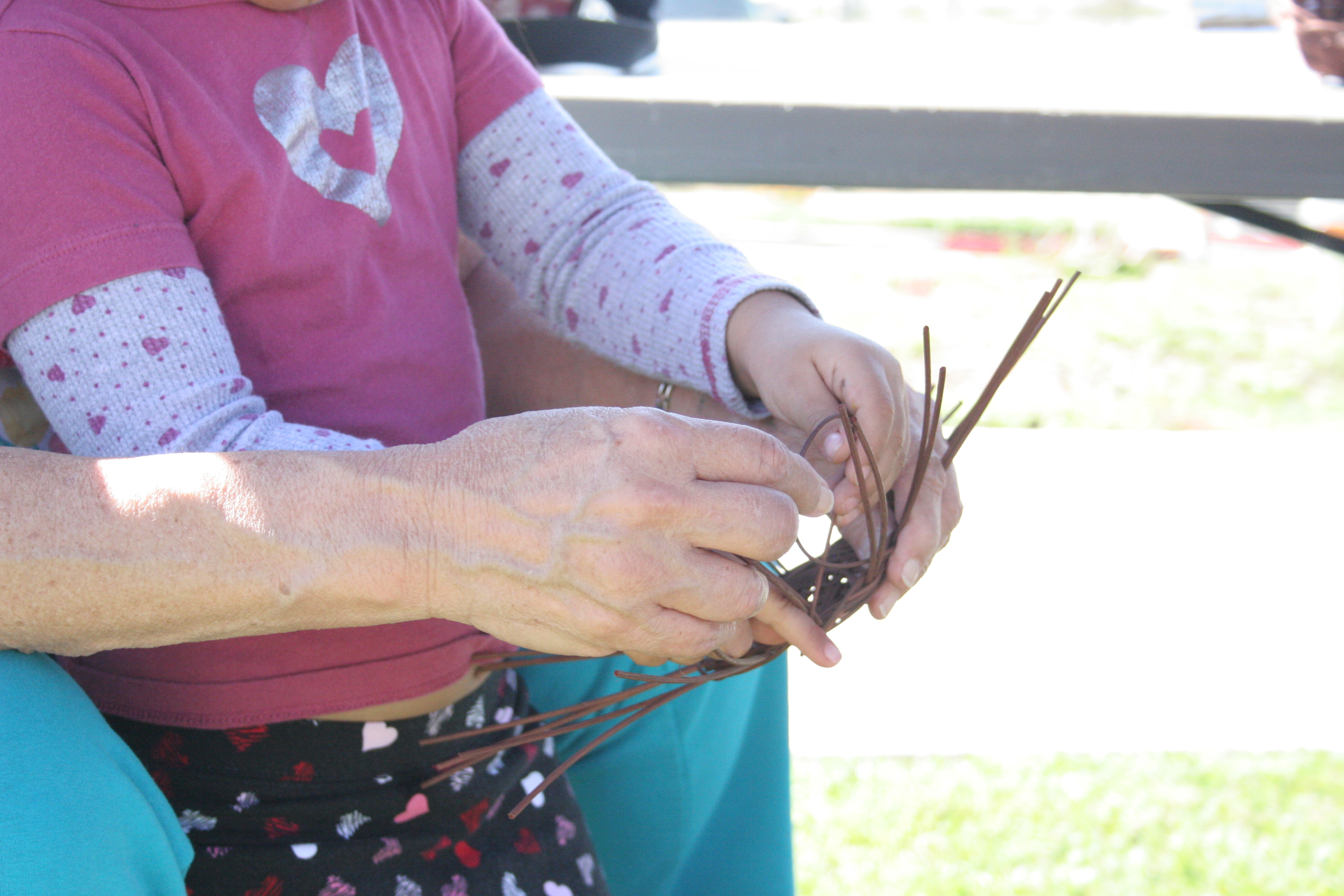 Elder teaches basketweaving 